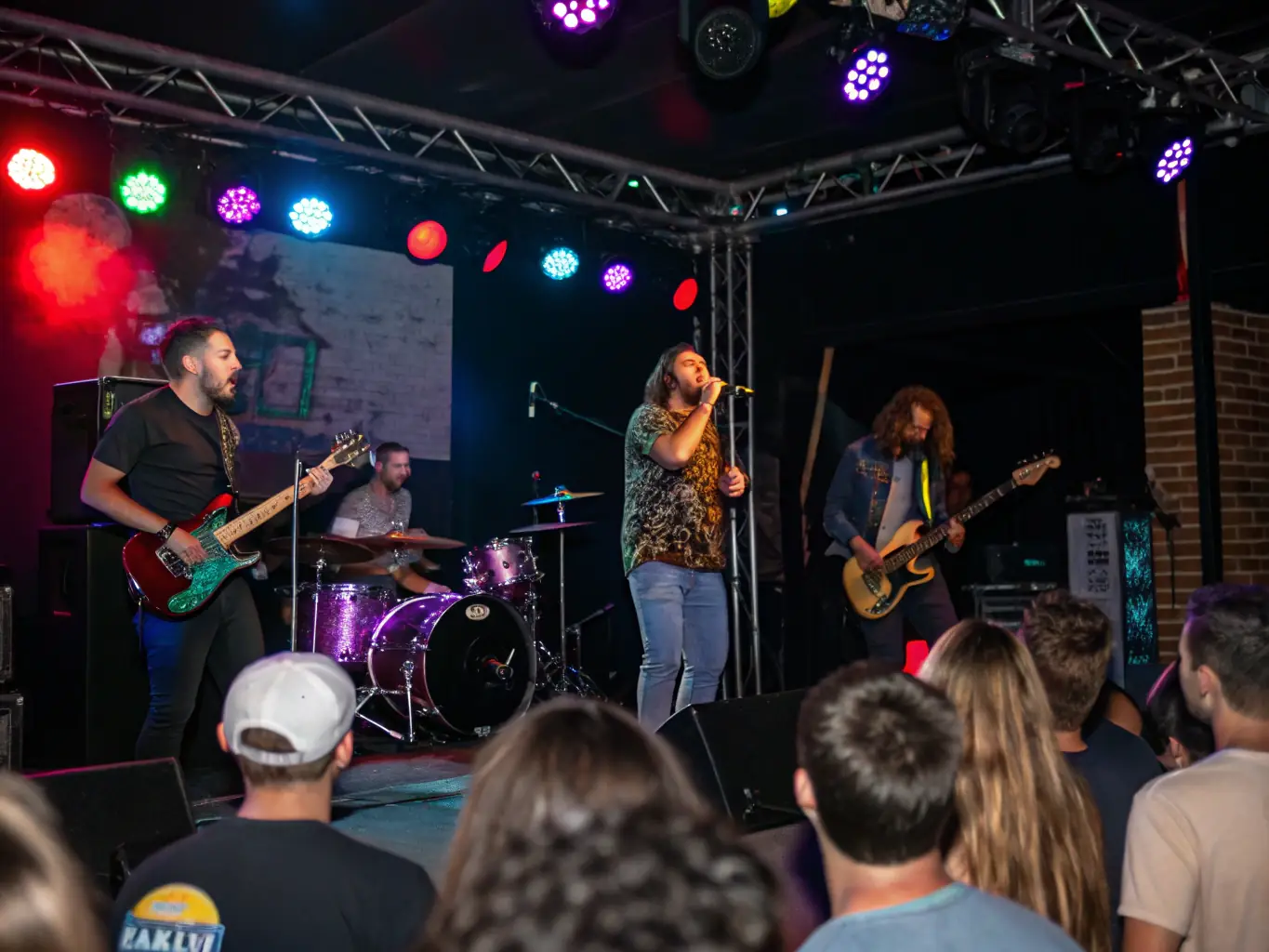 A live band performing on stage with an enthusiastic crowd, highlighting PISOKING CASINO's artist and talent management services.